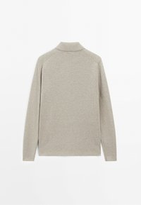 Long-sleeve beige sweater with a high collar shown from the back on a plain white background.
