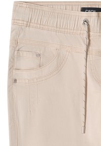 Pantalon beige avec taille élastique, cordon de serrage à l'avant, poche avant avec rivets métalliques et détails de couture visibles.