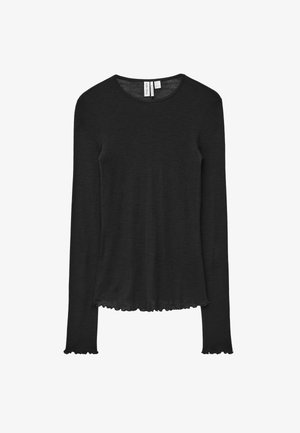Black long-sleeve top made of soft fabric, featuring a rounded neckline and scalloped edges at cuffs and hem, providing a relaxed fit.