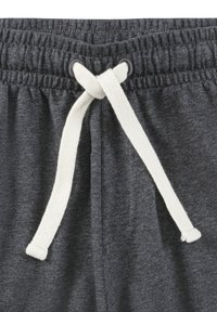 Dark gray sweatpants with elastic waistband and white drawstring tied in a knot at the front center.