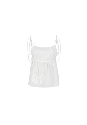 White sleeveless top with adjustable tie straps, featuring delicate embroidery on one side and a flowy, gathered hem. Soft fabric texture.