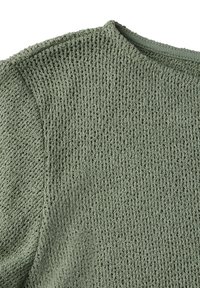 Zelený pletený svetr s texturou, který má široký výstřih a volný vzor tkaní s jemným povrchem. Materiál vypadá prodyšně a lehce.