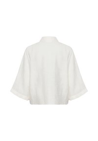 Chaqueta blanca corta con mangas anchas, tejido texturizado, patrón sutil y cuello clásico, que presenta un diseño limpio y minimalista.
