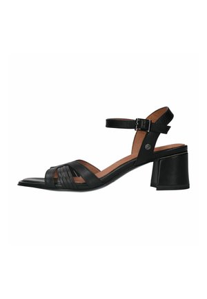 Black leather sandal with an open toe, featuring crisscross straps and an adjustable ankle strap, resting on a block heel.