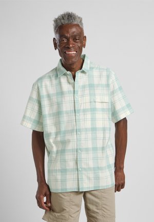 Camicia a maniche corte a quadri in verde chiaro e crema, design con bottoni, dotata di una tasca sul petto e realizzata in un tessuto morbido e texturizzato.