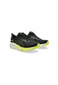 Black running shoes with bright yellow accents, featuring a sleek design, visible laces, and a cushioned sole, angled for visibility.