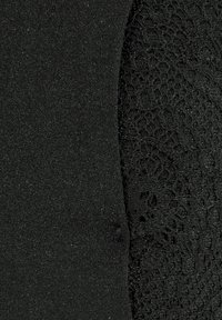 Black fabric featuring a smooth, shiny texture on one side and a lace detail with an intricate pattern on the other side, both in black.