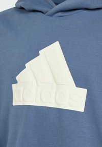 adidas Performance U FI LOGO HD - Jersey con capucha - preloved ink   ivory