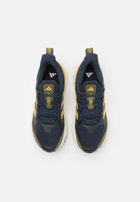 Navy blue athletic shoes with yellow accents, textured mesh upper, padded collar, and contrasting white and speckled sole.