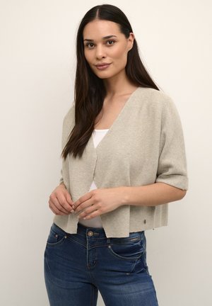 Light gray, cropped cardigan with a V-neck, short sleeves, and ribbed texture, worn over a white top and blue jeans.