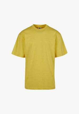 Gul bomulds T-shirt med en afslappet pasform, korte ærmer og rund halsudskæring. Glat tekstur, ingen mønstre eller detaljer.