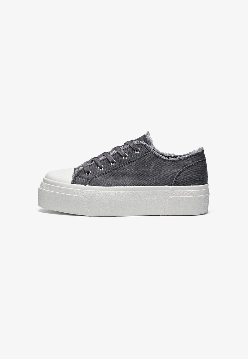 Gray denim sneakers with a white rubber sole, featuring a frayed edge at the ankle, gray laces, and metal eyelets.
