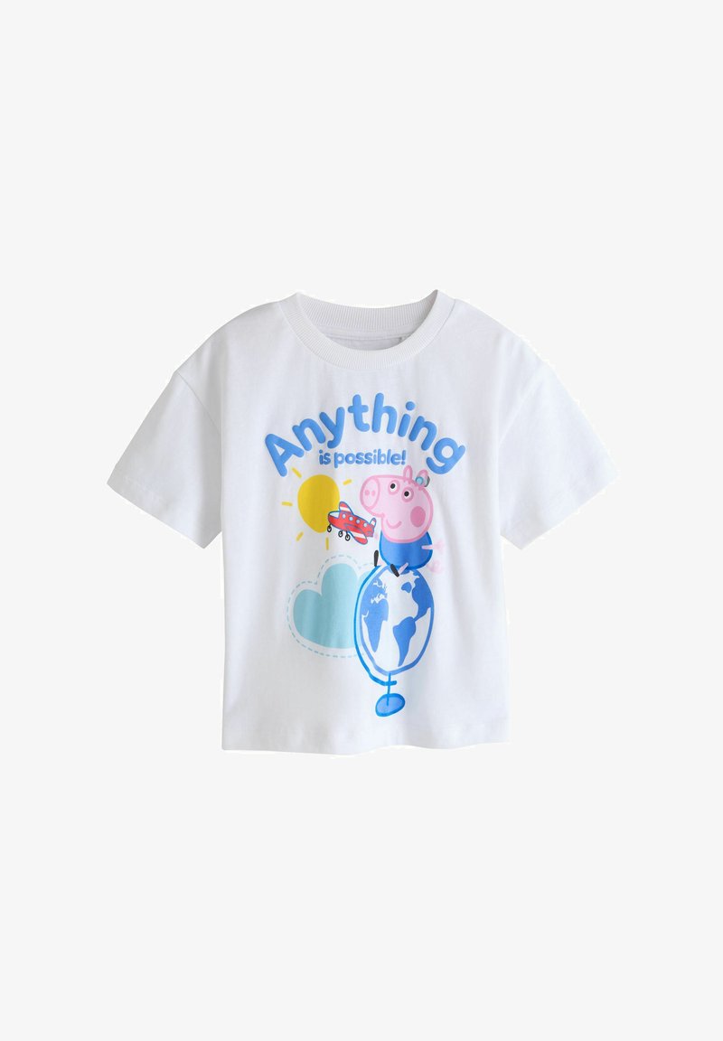 T-shirt blanc pour enfant avec un cochon de dessin animé debout sur un globe, un soleil jaune, un nuage bleu, un avion rouge et le texte « Tout est possible ! »