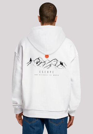 White hoodie featuring a mountain graphic, with "ESCAPE AND DISCOVER THE WORLD" text below. Includes an orange pull tab on the hood.