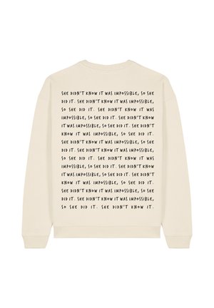 Cream-colored sweatshirt with a round neckline. Features repeated black text on the back, stating “She didn’t know it was impossible...”