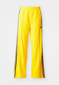 FIREBIRD - Tracksuit bottoms - yellow/black