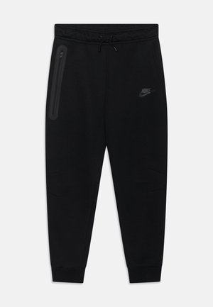 Svarta Nike-mjukisbyxor med dragsko i midjan, fickor med dragkedja på sidan, smalnande ben och subtil logotypdetalj på framsidan. Slät tygstruktur.