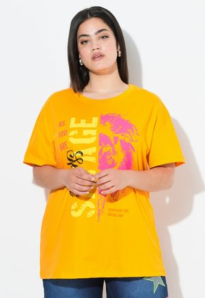 T-shirt arancione brillante a maniche corte con testo in grassetto e grafica di leone in rosa. Tessuto in cotone morbido con vestibilità comoda.