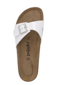 White flip-flop sandal with a glossy strap, metal buckle adorned with clear rhinestones, and a brown, textured insole.