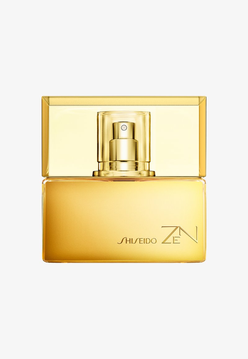 Kultainen suorakulmainen Shiseido Zen -hajuvesipullo, jossa läpinäkyvä suihkepää valkoisella taustalla.