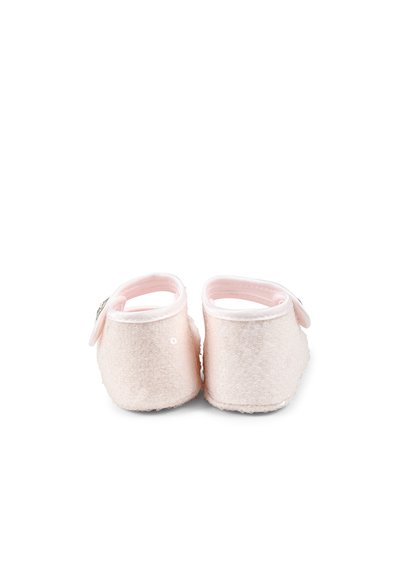 Chaussons en tissu doux rose avec une surface texturée, forme arrondie, bride de cheville et un petit élément décoratif sur le côté.