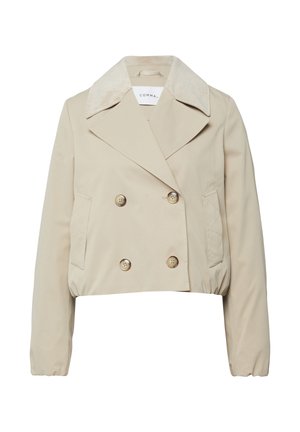 Beżowa, krótka, dwurzędowa kurtka z szerokim kołnierzem z sztruksu, czterema guzikami, dwoma skośnymi przednimi kieszeniami oraz elastycznymi mankietami i dołem.