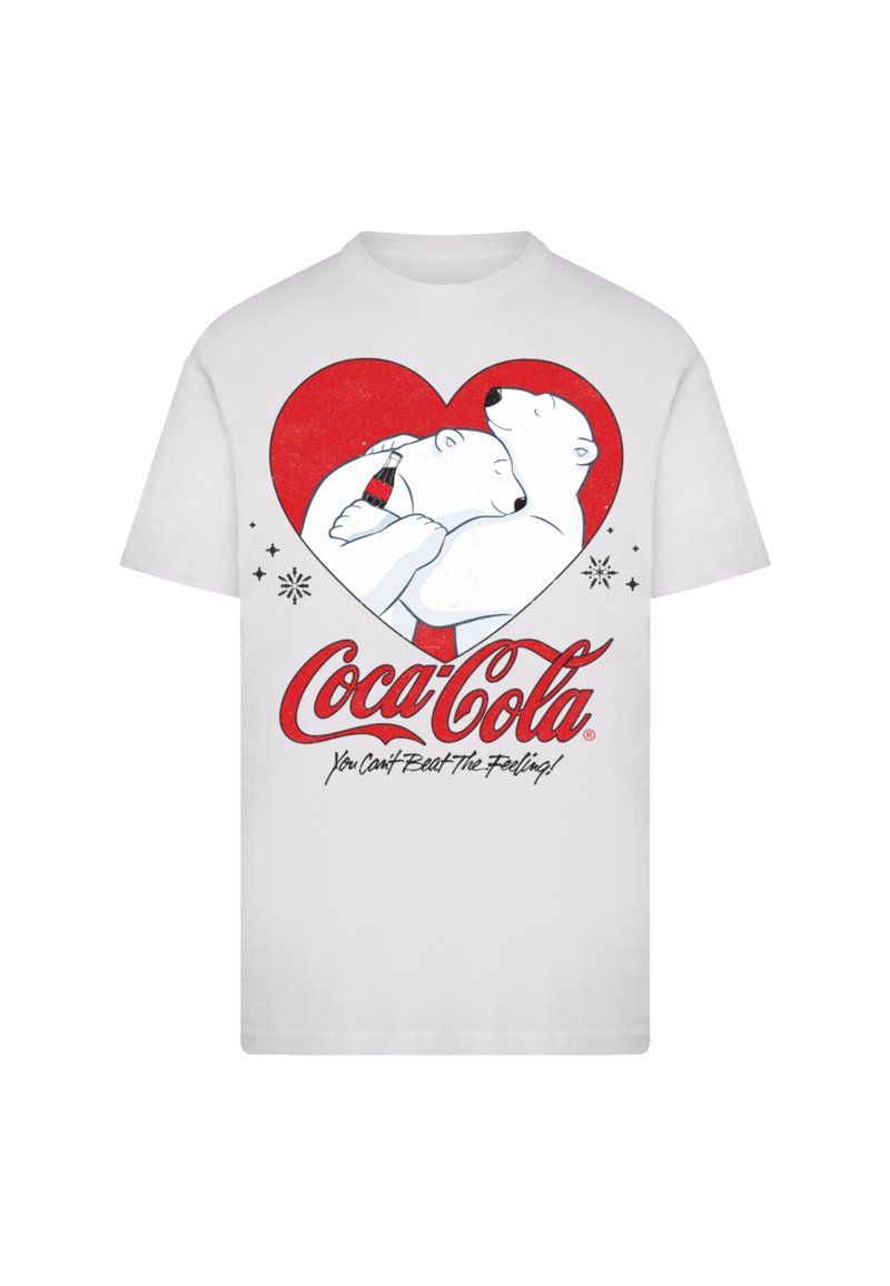 White t-shirt featuring a graphic of two polar bears in a red heart hugging, with a Coca-Cola bottle and the text "You Can't Beat the Feeling!"
