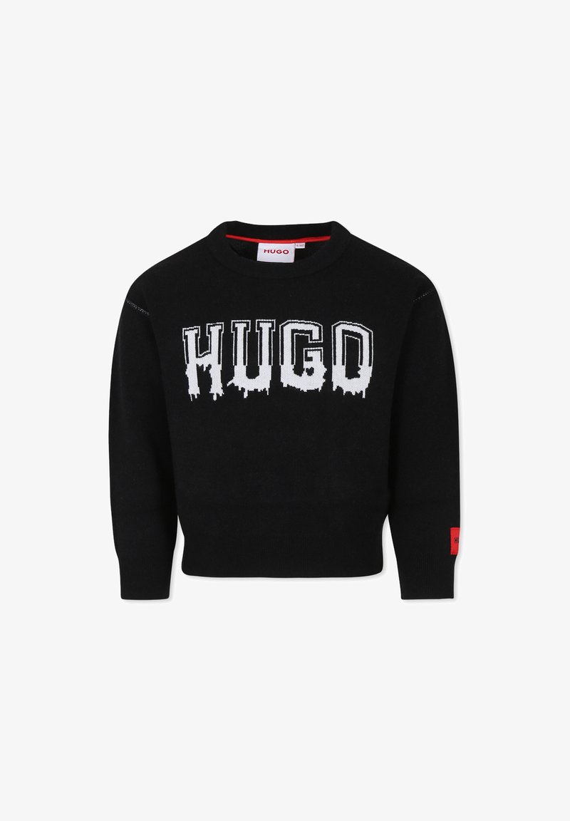 Maglione nero a maglia con collo rotondo. Presenta un logo "HUGO" bianco che gocciola sul petto e un'etichetta logo rossa sulla manica.