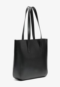 Black leather tote bag with smooth texture, two long handles, rectangular shape, and minimalistic design. No visible hardware or patterns.