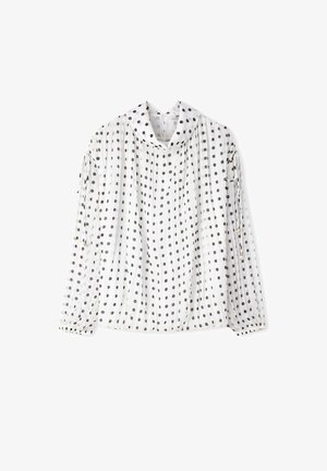 Blouse blanche à manches longues avec des pois noirs, tissu plissé, un large col entonnoir et des détails à cordon sur les manches.