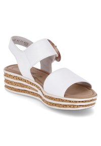 Sandales compensées blanches avec une semelle en liège texturé, présentant de larges sangles et un accent en forme de bouton rond. Matériau synthétique lisse et semelle intérieure rembourrée.