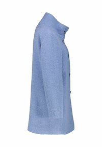 Cappotto testurizzato azzurro chiaro con colletto alto, chiusura frontale con bottoni e tasche laterali. Il design è rilassato e leggermente oversize.