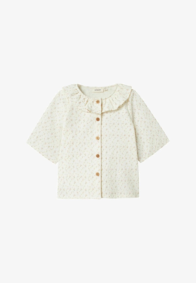 Kortärmad krämfärgad blus med rynkad krage, blommönster och träknappar fram. Tillverkad av mjukt, lätt tyg.