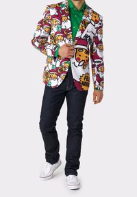 White blazer with colorful cartoon faces and text, featuring maroon and green accents. Worn with a green shirt and dark jeans.