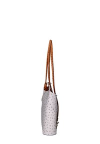 Sac à main en cuir blanc avec une surface texturée ornée de motifs en relief, complété par deux anses en cuir tressé marron.