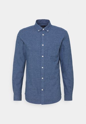 Blauwe button-up shirt in gestructureerde stof, met een kraag, een borstzak en witte knopen. Lange mouwen met een ronde zoom.