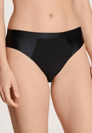 Black bikini briefs made of smooth, stretchy fabric. Features a low-rise waist and contrasting matte and shiny texture.