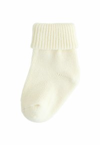 Cremefarbener gestrickter Socken mit geripptem Bündchen, der eine weiche Textur und ein rundes Zehendesign aufweist, geeignet für Komfort und Wärme.