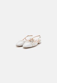 White satin slingback shoes with a low block heel, featuring floral lace detailing on the vamp and an adjustable ankle strap.