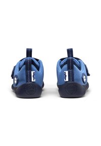 Scarpe in tessuto blu con suole in gomma scura, cinturini regolabili con Velcro e linguette posteriori per indossarle facilmente. Dettagli del design adatti ai bambini.