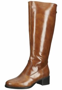 Botte en cuir brun montante avec une finition brillante, bout rond, panneau latéral élastique et un petit talon carré. Texture lisse, coutures minimales.