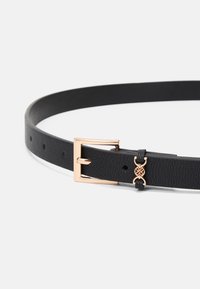 Curea din piele neagră cu un finisaj texturat, având o cataramă din metal de culoare aurie și un accent decorativ lângă cataramă cu detalii circulare.