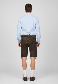 Men's outfit featuring a light blue button-up shirt and brown leather shorts. The shorts have side ties and a back pocket detail.