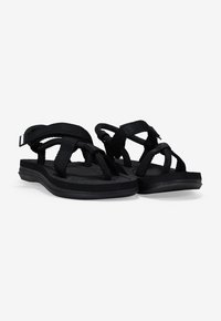 Black sandals with fabric straps, textured footbed, and a curved rubber sole. Features a simple design with adjustable bands for comfort.