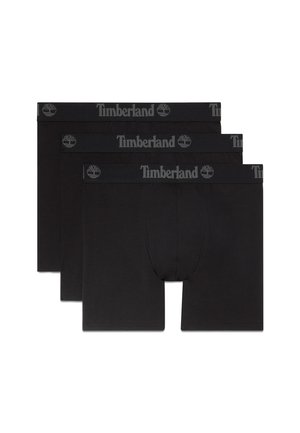 Drie paar zwarte boxershorts met Timberland-logo en boomicoon op de tailleband, gerangschikt in een licht overlappende stapel.