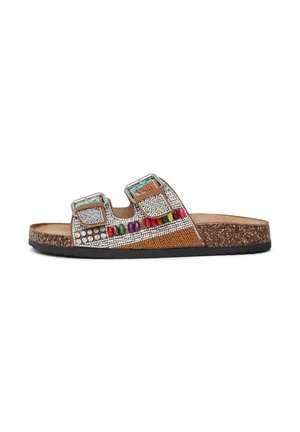 Brown slide sandal featuring two adjustable silver buckles, colorful bead accents, and a textured cork sole with a black rubber bottom.