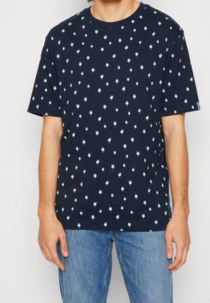 Navy blue short-sleeve t-shirt made of cotton with a pattern of small light blue flowers. Features a round neckline and loose fit.