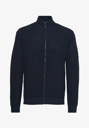 Cardigan navy con zip in tessuto a maglia testurizzata, con colletto alto e polsini a coste. Colore uniforme con accenti minimi.