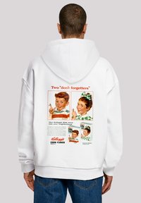 White hoodie featuring retro Kellogg's Corn Flakes graphics on the back, including two children and text. Soft fabric, relaxed fit.