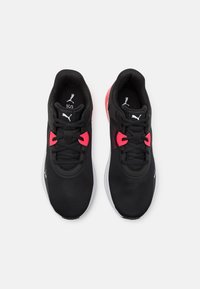 Black athletic shoes made of mesh with pink accents. Features a rounded toe, lace-up front, and cushioned sole with logo details.